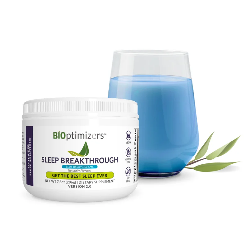 A tub of Sleep Breakthrough beside a glass of the mixed blue drink